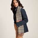 Side view of Beige ivy check scarf around a ladies neck.