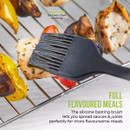 Close-up of silicone basting brush from the Tower air fryer accessories set applying sauce to chicken skewers, highlighting BPA-free food-safe construction.