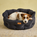 Dog lying comfortably inside the Joules Chesterfield round grey pet bed. Dog lying comfortably inside the Joules Chesterfield round grey pet bed.