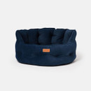 Side view of Joules Chesterfield navy dog bed showing padded design and raised sides. Side view of Joules Chesterfield navy dog bed showing padded design and raised sides.