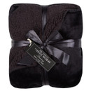 A black fluffy blanket folded and finished with a matching bow on a white background