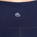 Close-up of the rear waistband on women's navy performance leggings, featuring a reflective logo for enhanced visibility in low-light conditions.