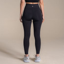 Rear view of women's black high-waisted performance leggings, showcasing the supportive waistband, streamlined fit and reflective logo detail.