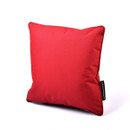 A bright red square pillow with a smooth texture is centered on a white background. The pillow has a small black tag on the right edge.