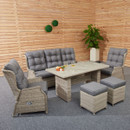 Outdoor patio set with grey cushions in a wooden-walled room. Includes a sofa, armchairs, ottomans, and a table. Potted plant adds greenery. Cosy ambiance.