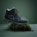 A Navy walking boot with light blue accents on a rock