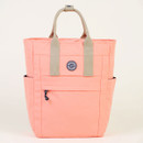 Peach-coloured tote bag with side pockets and a circular logo on a light background.