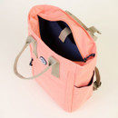 A Coral-coloured backpack with an open-top and a visible dark interior against a white background.