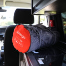 A rolled-up grey sleeping bag with a red end cap, marked "Vango" and "5CM," rests on a campervan counter, conveying readiness for adventure.