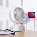 White Daewoo mini desk fan on a wooden desk next to a notebook, shown in a home office setting.