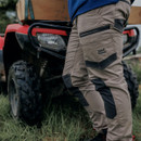 Rear side view of beige Hard Yakka trousers with branded cargo pocket, reinforced knee panels and utility storage