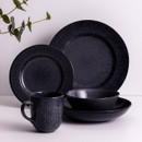 Charcoal grey reactive glaze dinnerware collection featuring matching plates, bowls and mug