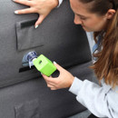 A battery operated air pump is being used to inflate a grey inflatable chair