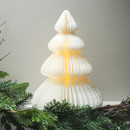 Pre-lit white paper Christmas tree decoration illuminated with a warm white glow, displayed among festive greenery.