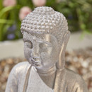 Close-up of the Buddha’s face and textured hair detail on the stone-effect water feature.