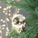 White mice tucked inside a glittered gold pine cone hanging decoration with a red ribbon, displayed on a Christmas tree branch.