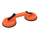 An orange dual suction cup lifter with black levers, designed for lifting glass or smooth surfaces, placed on a white background.