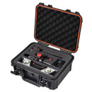 Open black hard-shell case with foam padding containing various compact electronic devices and accessories. Case interior is organized and secure.