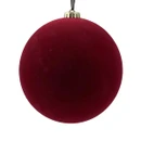 A plush red Christmas ornament with a gold cap, hanging against a plain white background.