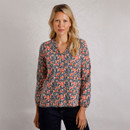 A woman wearing a printed blouse.