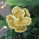 A view of a gold glitter flower pick on a Christmas tree