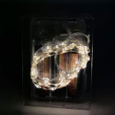 Battery-operated warm white LED fairy lights coiled in a clear storage box, ideal for indoor Christmas décor, craft projects and seasonal lighting arrangements.