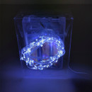 A clear box contains a glowing blue LED string light, coiled neatly inside, set against a dark background.