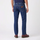 Back view of dark blue straight-leg jeans on a model, cropped from waist to shoes.