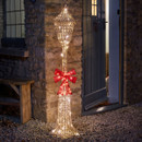 An LED lamp post with a bow in front of a partly opened door