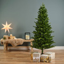 Slim artificial Christmas tree displayed indoors with wrapped gifts and festive décor, featuring a narrow profile ideal for smaller spaces and modern homes.