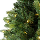 Close-up of realistic artificial pine branches with integrated warm white LED lights and natural-looking green needle detail.
