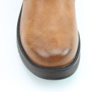 Close-up of the boot’s rounded tan toe, showing its textured surface, darker shading around the tip and dark sole edge.