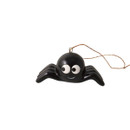 A black cartoon spider with big white eyes and string threaded through a hook at the top.