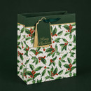 Holly print Christmas gift bag with dark green ribbon handles and a coordinating gift tag featuring gold "Merry Christmas" lettering.
