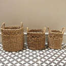 Set of three matching baskets in different sizes on a grey background and tiled floor