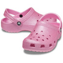 A pair of pink clogs with textured soles and perforated tops, featuring a strap with a button detail. The shoes convey a casual and playful tone.