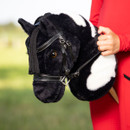 A black and white piebald hobby horse being held by a child