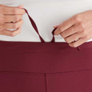 A close-up view of the waist adjuster on a burgundy pair of Ridgeline women's infinity leggings.