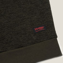 Close-up of a dark green fabric with a "Hoggs Professional" logo tag and a solid green trim.