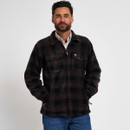 Man wearing a dark brown and black checked fleece overshirt with blue jeans, front view with hands in pockets.