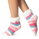 A close up of someone's feet wearing thick striped slipper socks with a soft turn over lining, the socks reach just above the ankle.