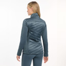 A woman with her back to the camera wearing a petrol blue coloured jacket on a grey background
