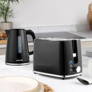 A black electric kettle and toaster on a kitchen counter.