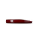 A dark red spoon rest from the side