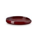 A dark red spoon rest