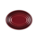 A dark red oval spoon rest from above