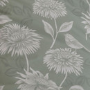 A close up of a green duvet set with white chrysanthemum florals.