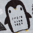 Close-up of a cute cartoon penguin design on a grey bath mat.