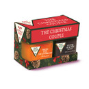 Festive gift box labelled "The Christmas Couple" containing Bucks Fizz marmalade and Festive Fig & Port chutney, adorned with holly and pinecone design.