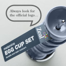 A stack of blue melamine egg cups with a label reading "Egg Cup Set" and a reminder to look for the official logo.